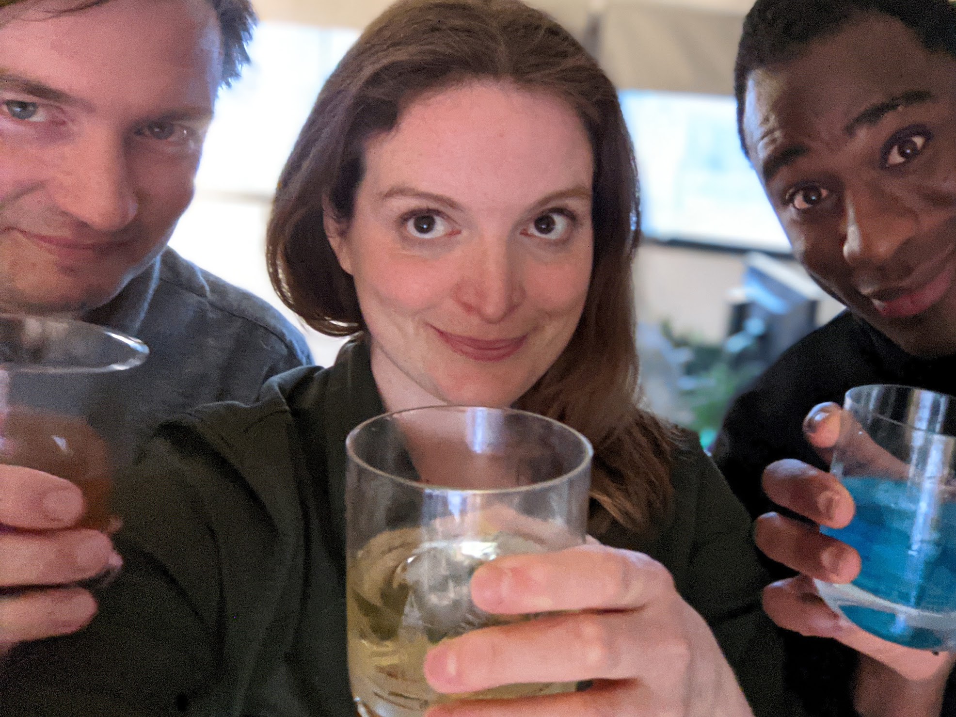 three people holding drinks